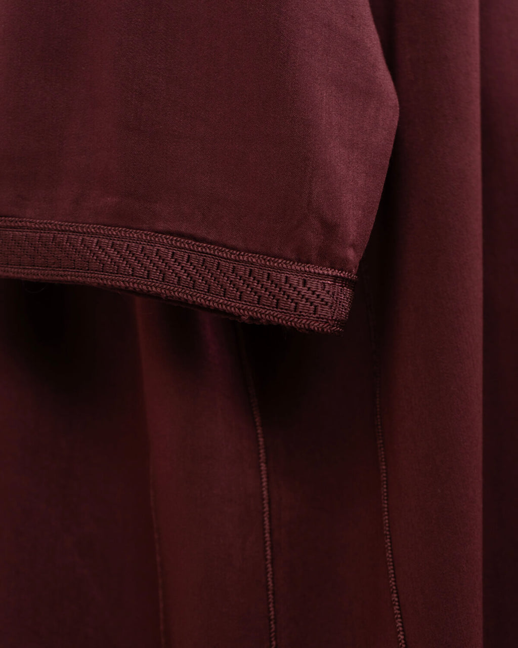 mannequin portant djellaba homme matiere legere de couleur bordeaux avec un travail finition faite main vue details-rapproches