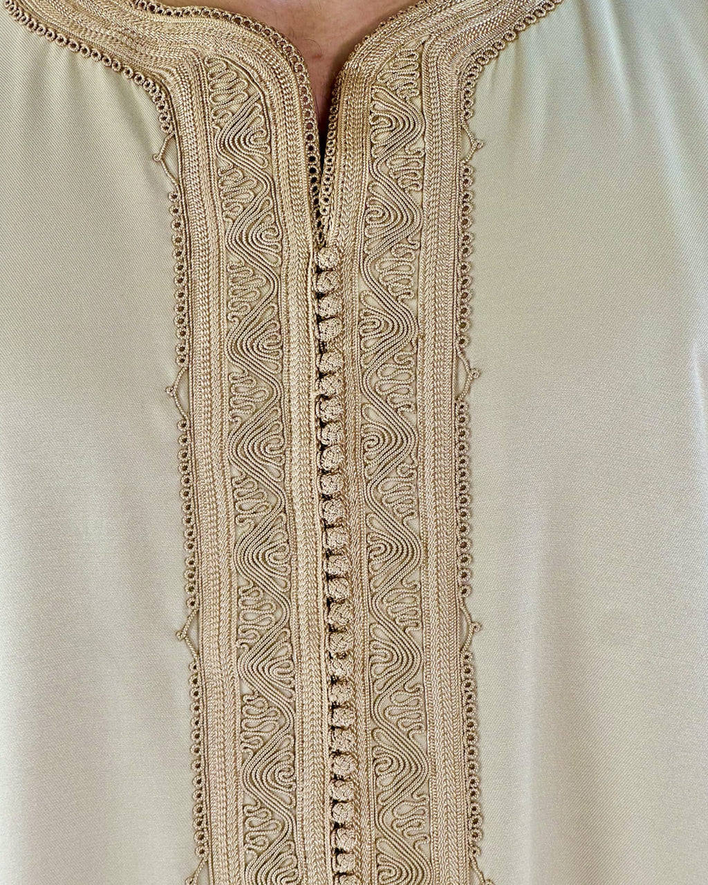 mannequin portant gandoura homme matiere gabardine de couleur beige avec un travail motifs fait main vue motifs