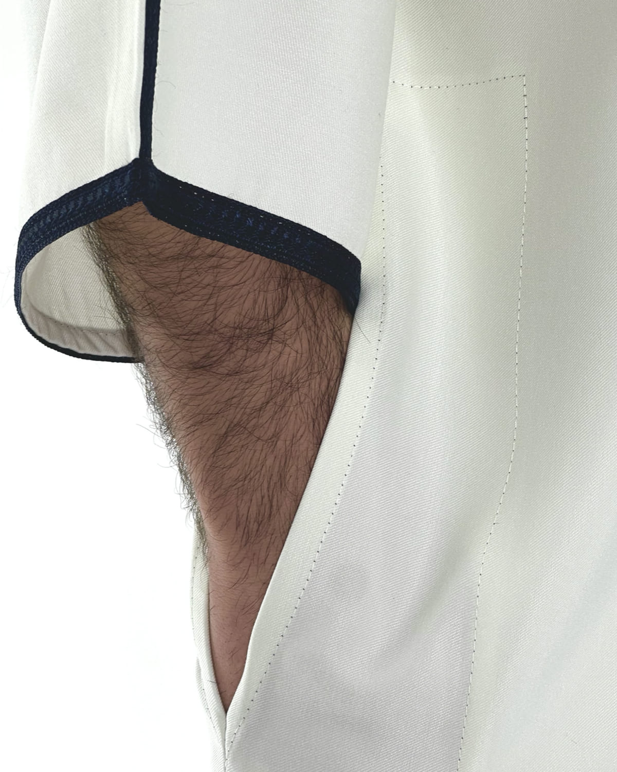 mannequin portant gandoura homme matiere gabardine de couleur blanc-et-bleu avec un travail motifs traditionnels brodés vue manche