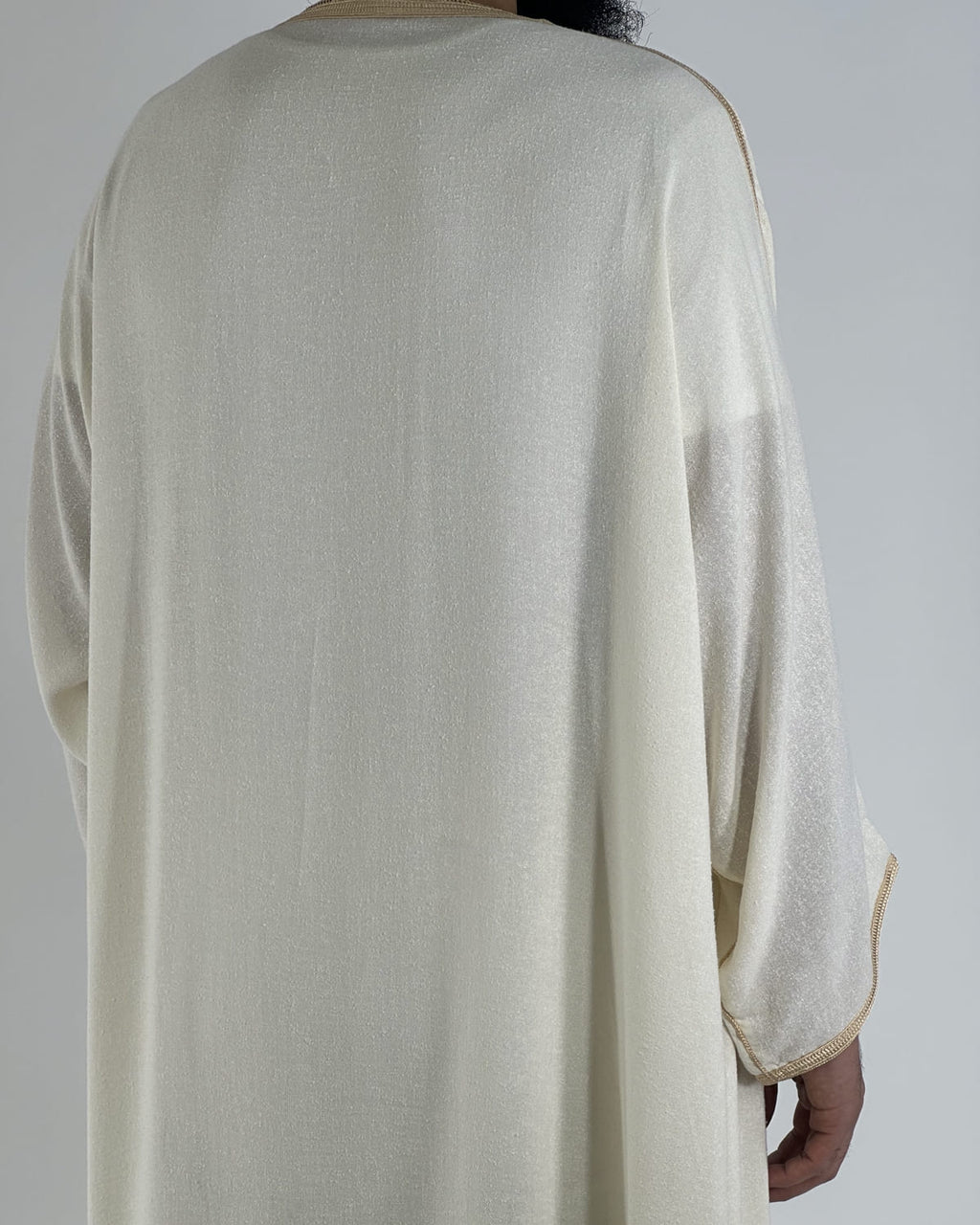 mannequin portant gandoura homme matiere lin de couleur beige avec un travail motifs fait main vue dos