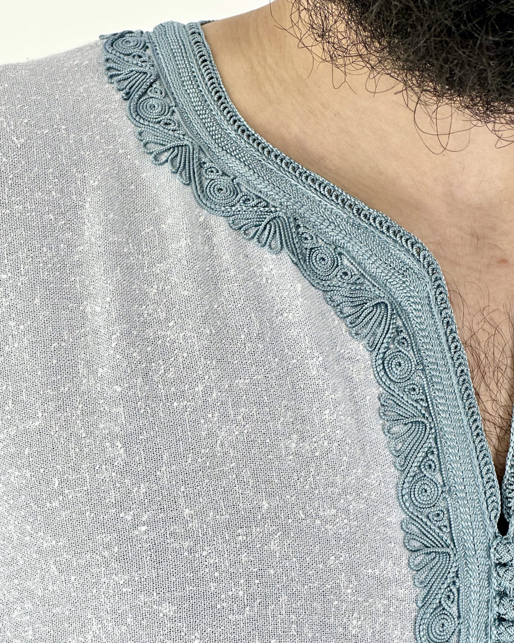 mannequin portant gandoura homme matiere lin de couleur bleu avec un travail motifs fait main vue details-rapproches