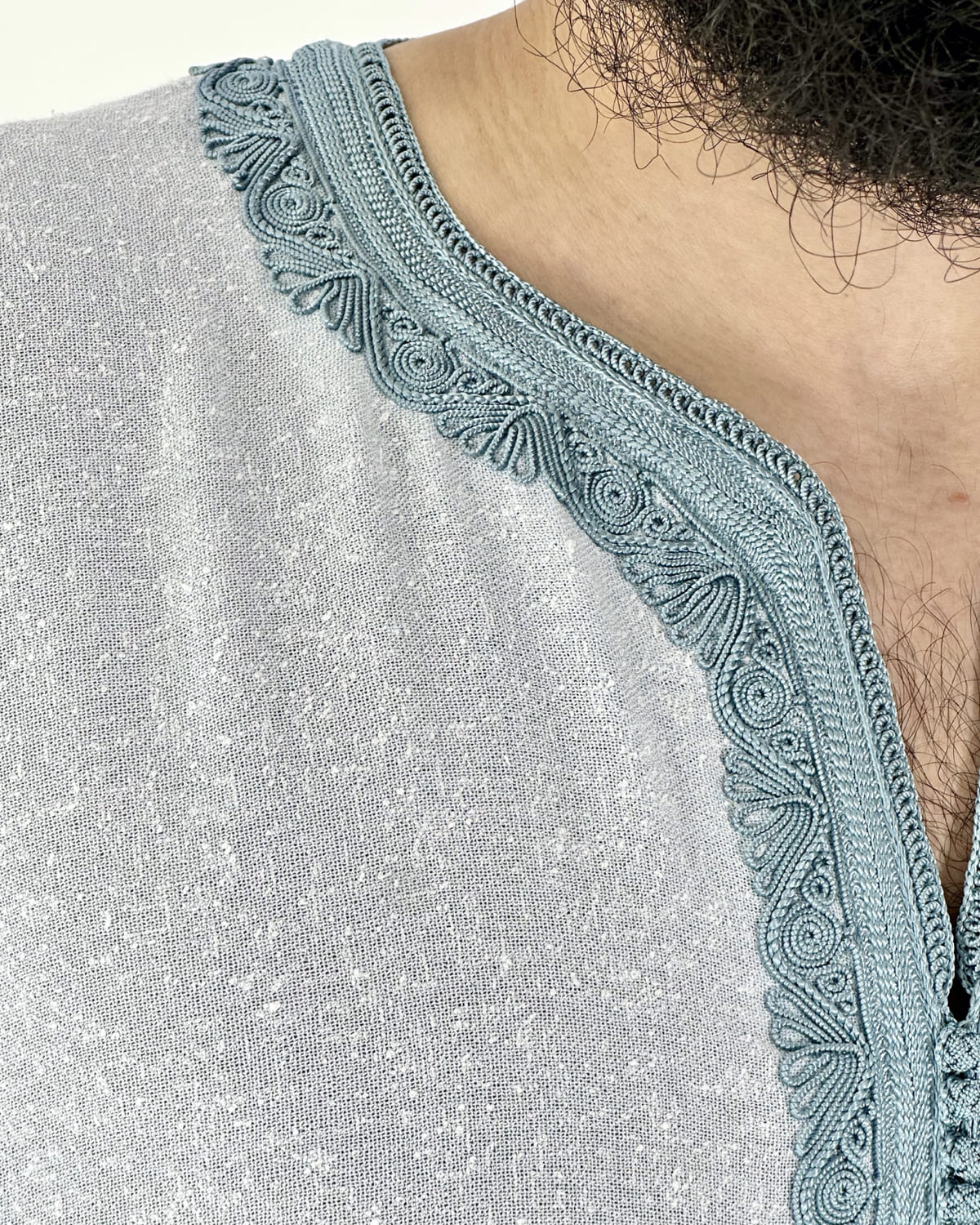 mannequin portant gandoura homme matiere lin de couleur bleu avec un travail motifs fait main vue details-rapproches